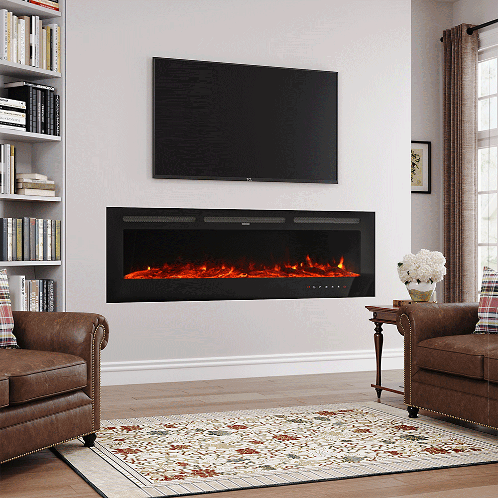 Large glass-front electric fireplace with vibrant orange flames and touch screen controls, mounted on a modern white wall beneath a TV, surrounded by a cozy living room setup with leather armchairs, a floral rug, and a built-in bookshelf.