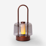 portable lantern-style ambient table lamp beside books and evening decor