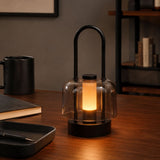portable lantern-style ambient table lamp on a desk with soft ambient light