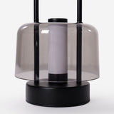 portable lantern-style ambient table lamp on a desk with soft ambient light