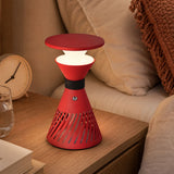 retro funnel cordless table lamp glowing on a bedside table