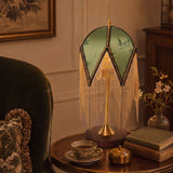 mid-century tassel table lamp on a desk with soft ambient light