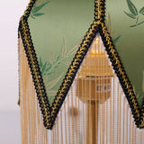 mid-century tassel table lamp with a warm diffused glow