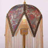 mid-century tassel table lamp with a warm diffused glow
