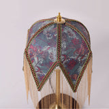 mid-century tassel table lamp styled on a small side table