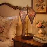 mid-century tassel table lamp adding warm light to a bedroom