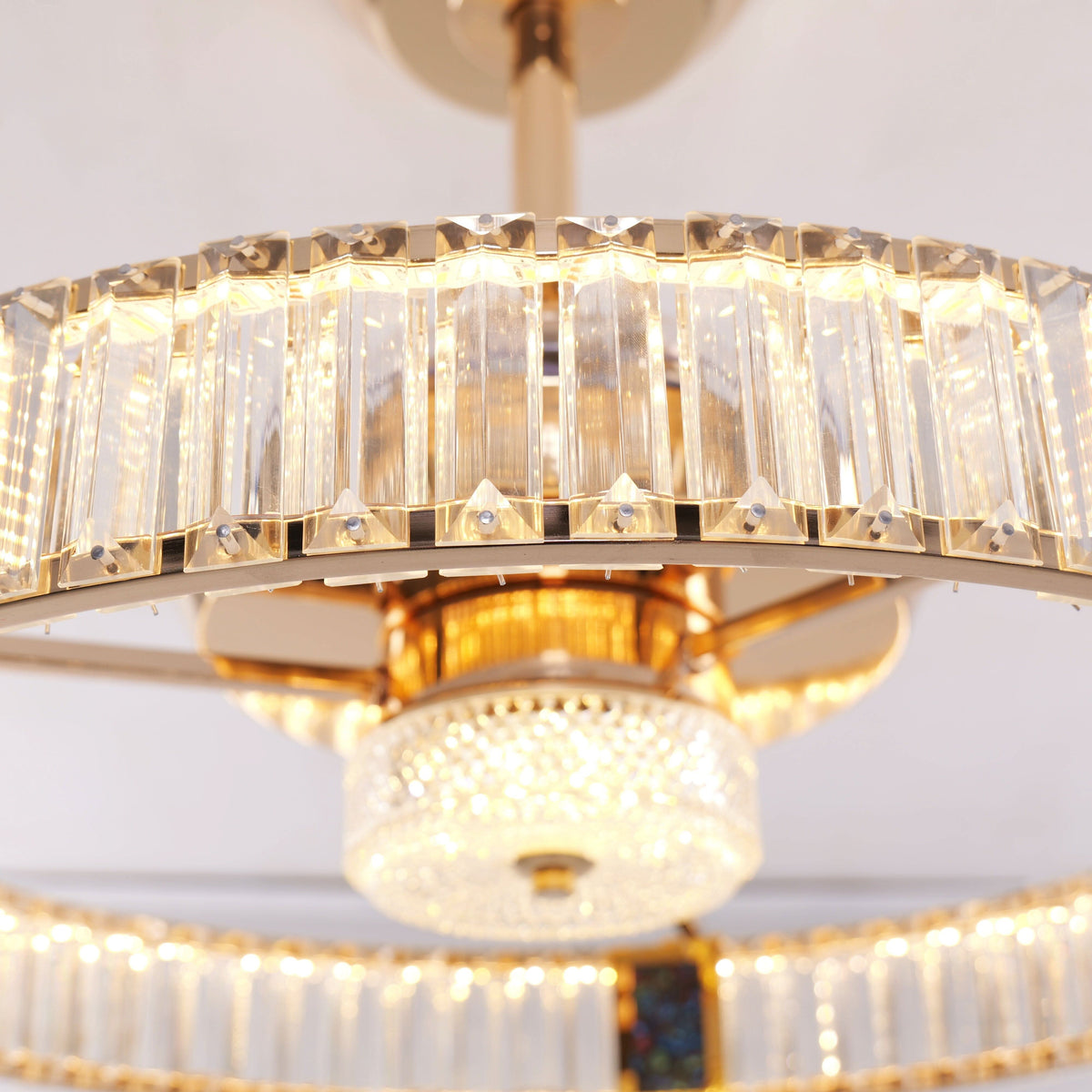 Gold crystal ceiling fan light detail showing frame, shade and fan blades